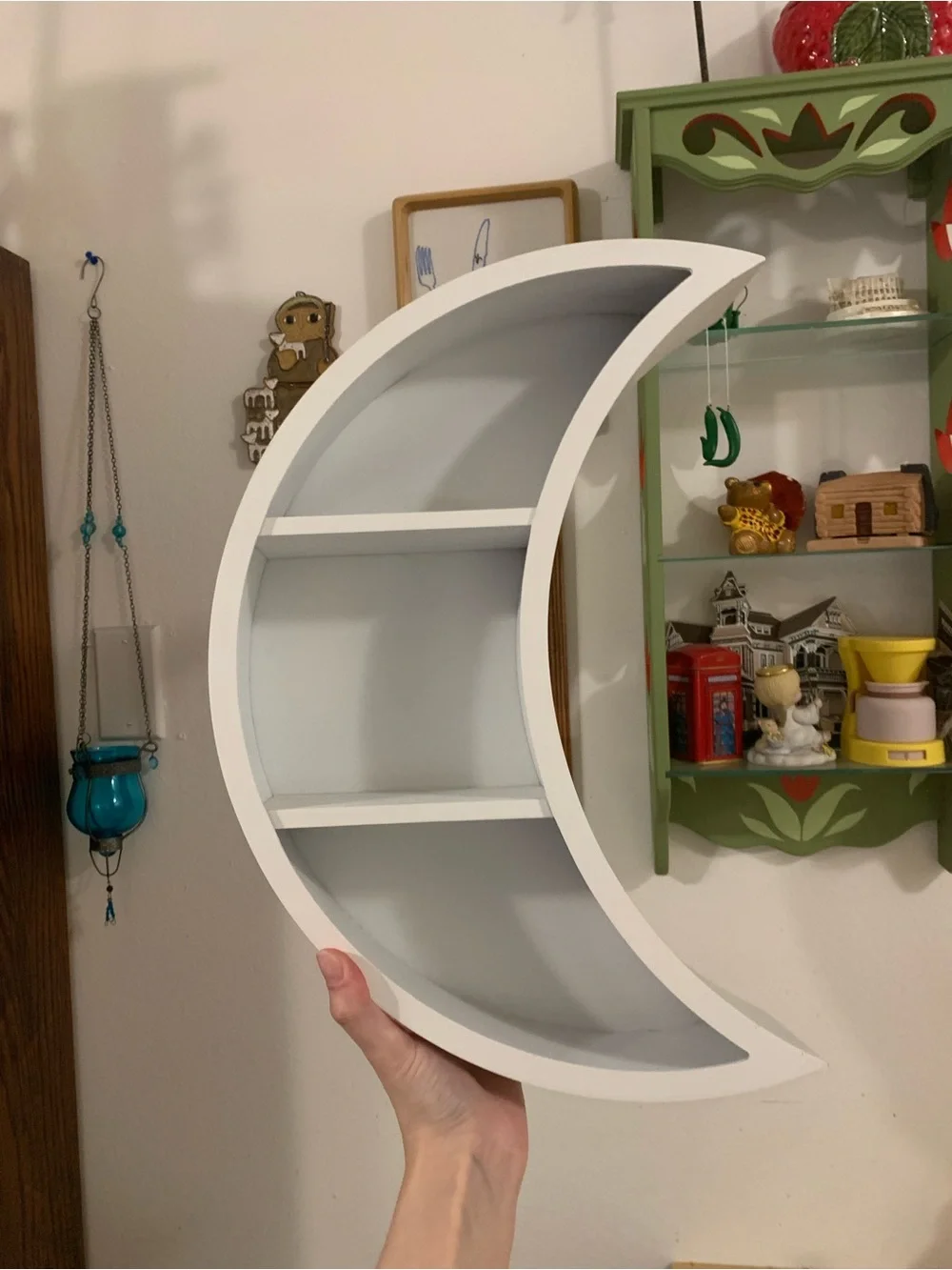 White crescent moon wall shelf faces either way